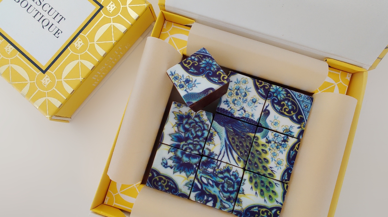 peacock design biscuits in a gold box