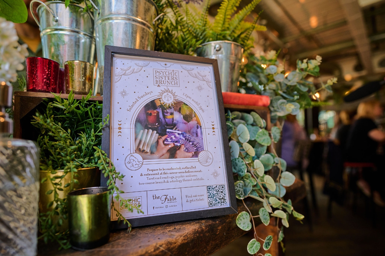 flyer notice on a shelf surrounded by plants 
