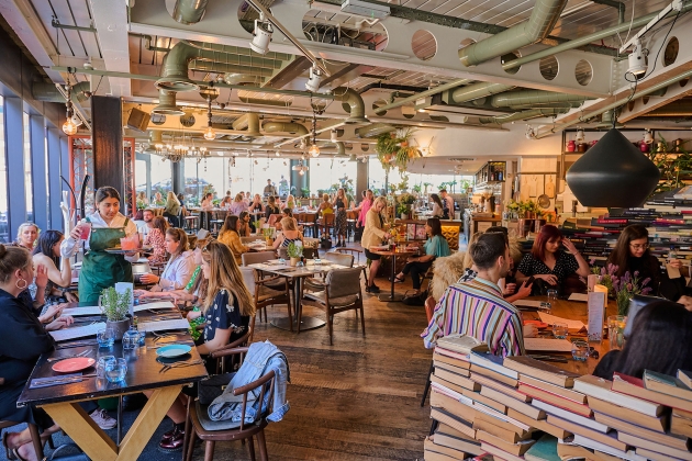 restaurant interior with lots of groups sat at table and chairs