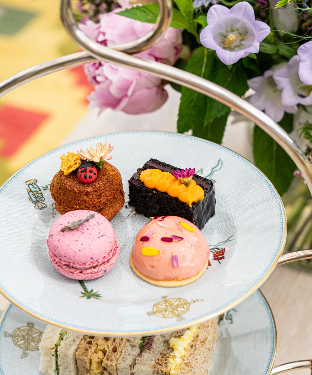 afternoon tea cakes and sandwiches on a plate stand