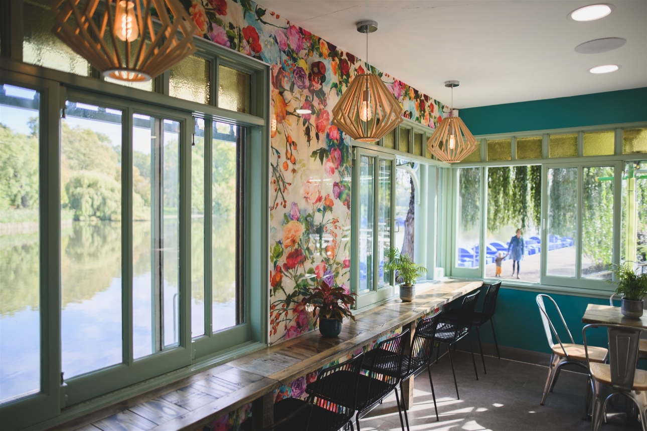Waterside Café floral wallpaper and larger windows looking out at river