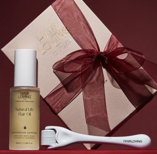 Pink box with hair oil and roller. 