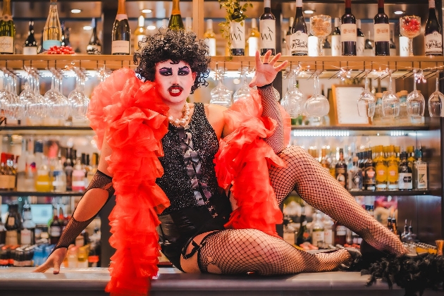 Character on bar with red costume