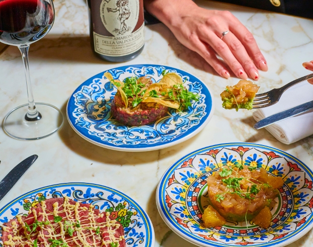 Blue plates with Italian food and wine. 