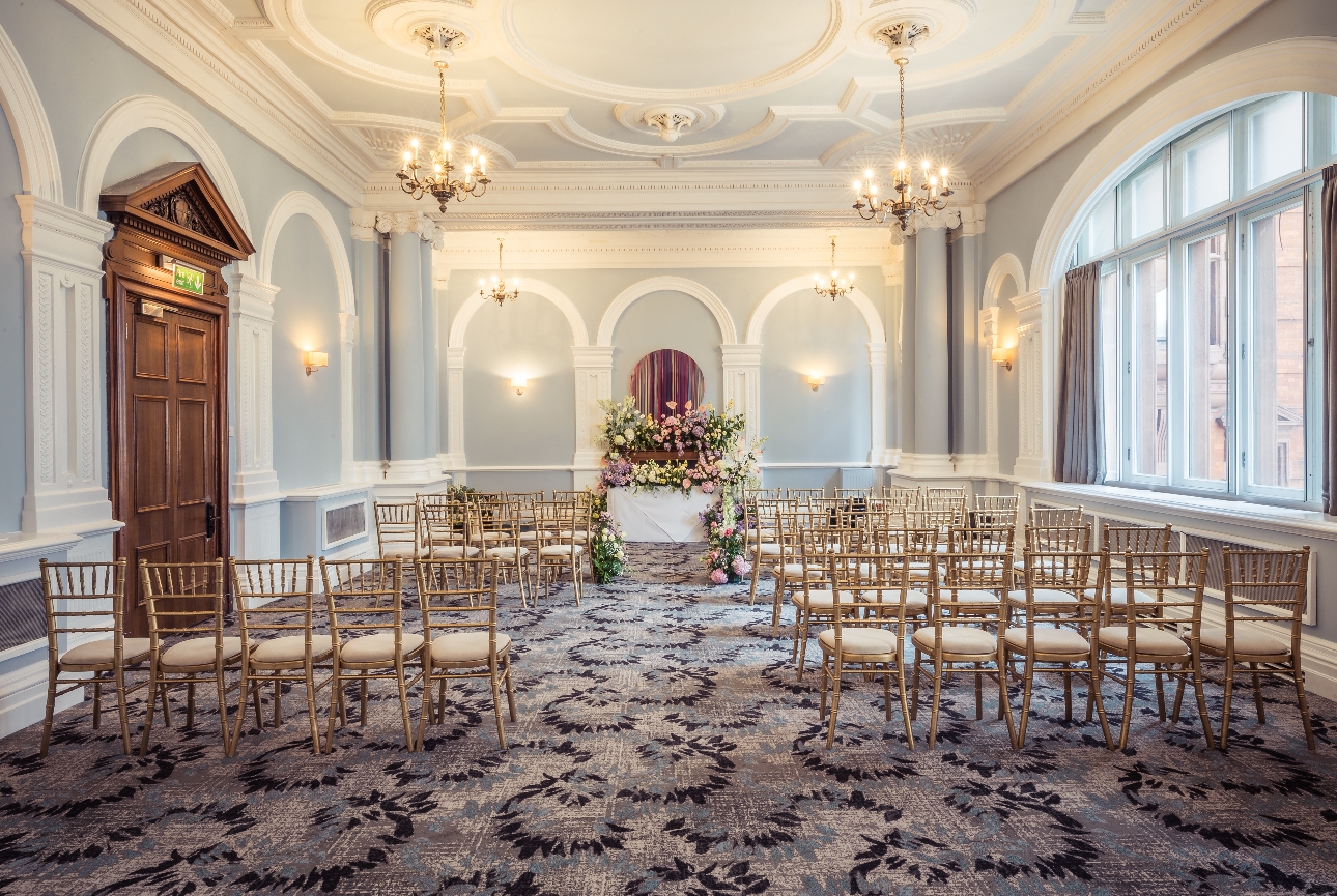 ceremony room with gold chairs blue walls white cornicing