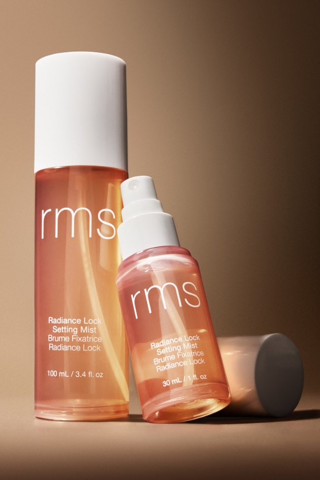 two spray bottles with beige background