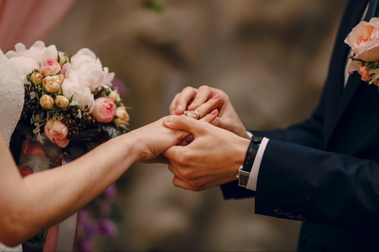 couple getting married with wedding rings