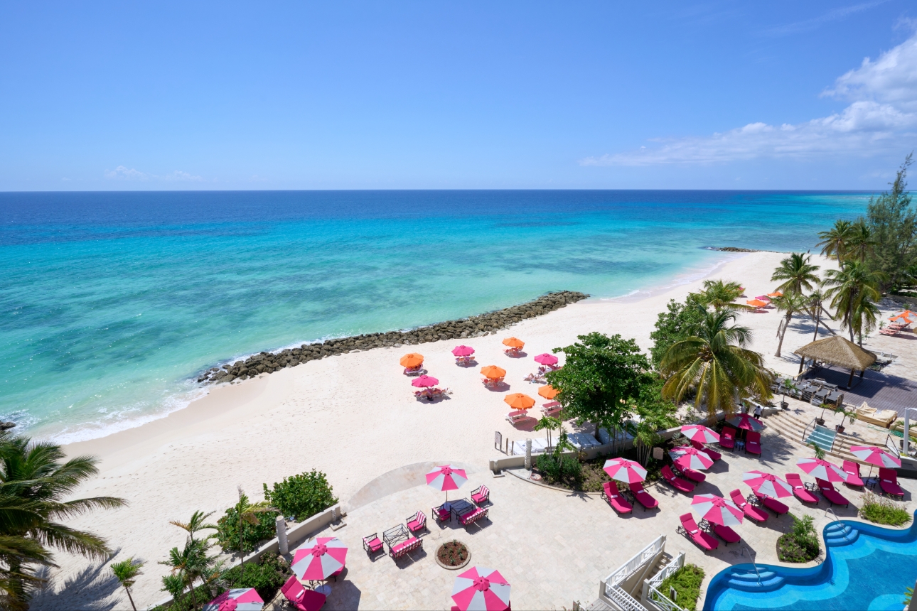 Barbados coast line hotel with white and pink parasols