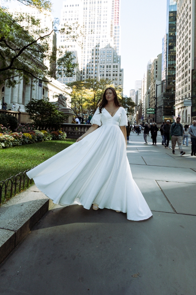 a plunging neckline, scoop back, and softly-lined puff sleeves dress